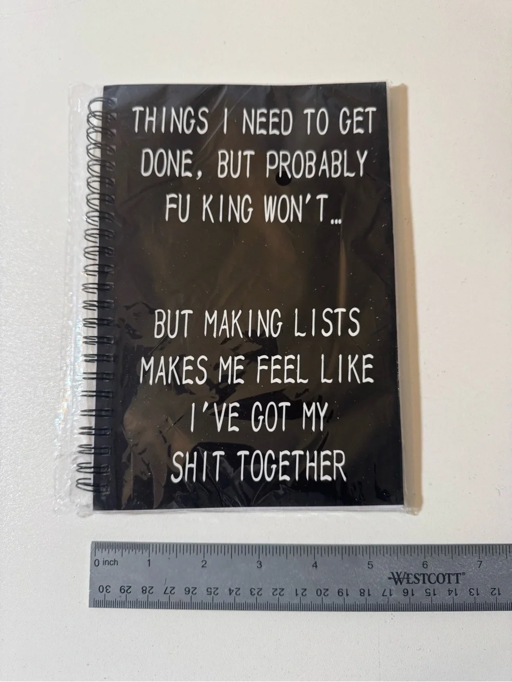 Black Spiral Notebook with White Text 
